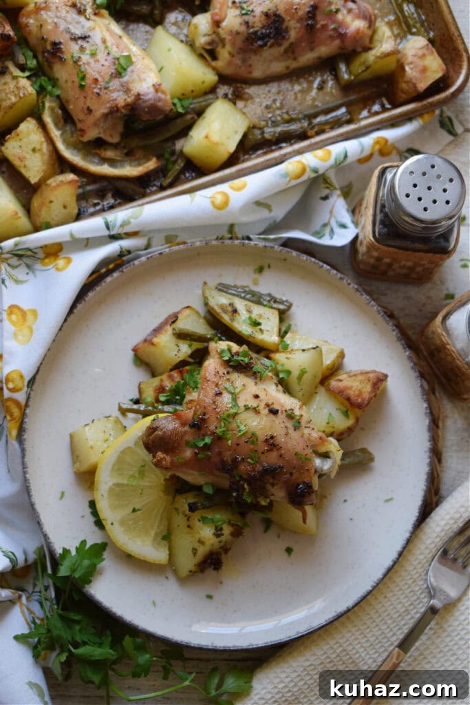 Sheet Pan Lemon Herb Chicken with Roasted Vegetables 4 Lemon herb butter chicken on a plate.