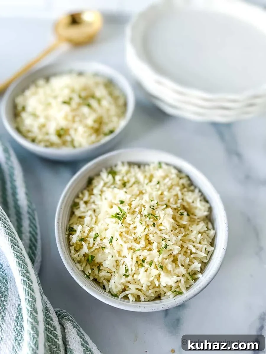 How to Make Fluffy Basmati Rice in an Instant Pot 2 Two white bowls of Instant Pot Rice with a stack of white plates, striped cloth, and golden serving spoon at the background.