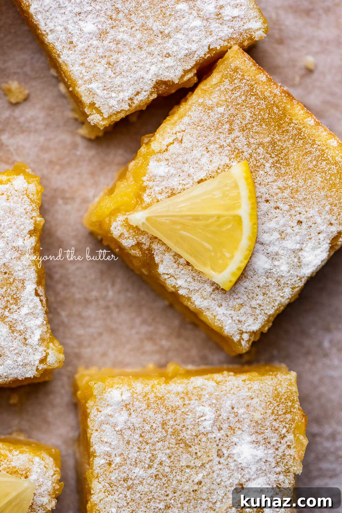 Tangy Lemon Bars with Buttery Shortbread Crust 3 Tart and tangy lemon bars on parchment paper
