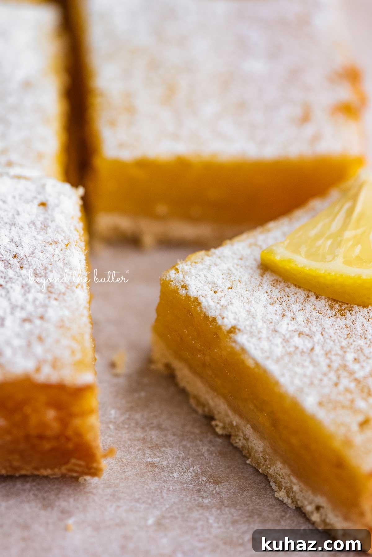 Tangy Lemon Bars with Buttery Shortbread Crust 7 Super easy lemon bars on parchment paper