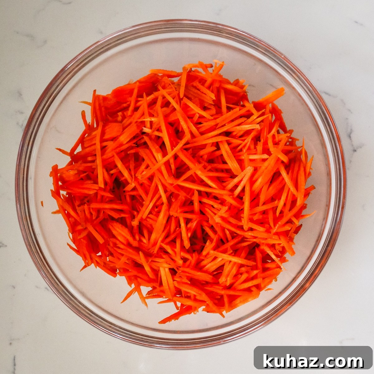 Spicy Morkovcha Korean Carrot Salad Recipe 6 shredded carrots in a glass bowl.