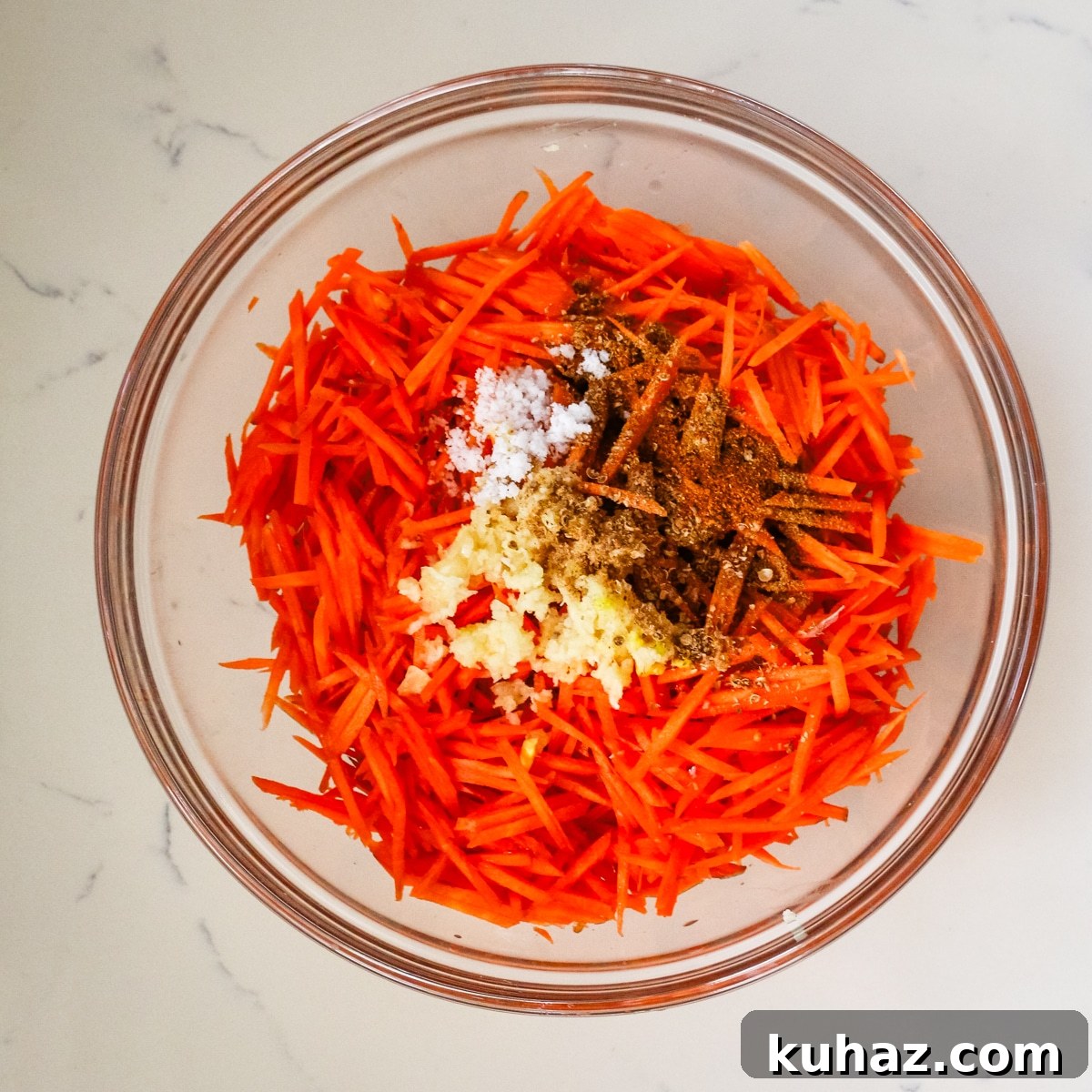 Spicy Morkovcha Korean Carrot Salad Recipe 7 korean carrot salad with seasoning in glass bowl.