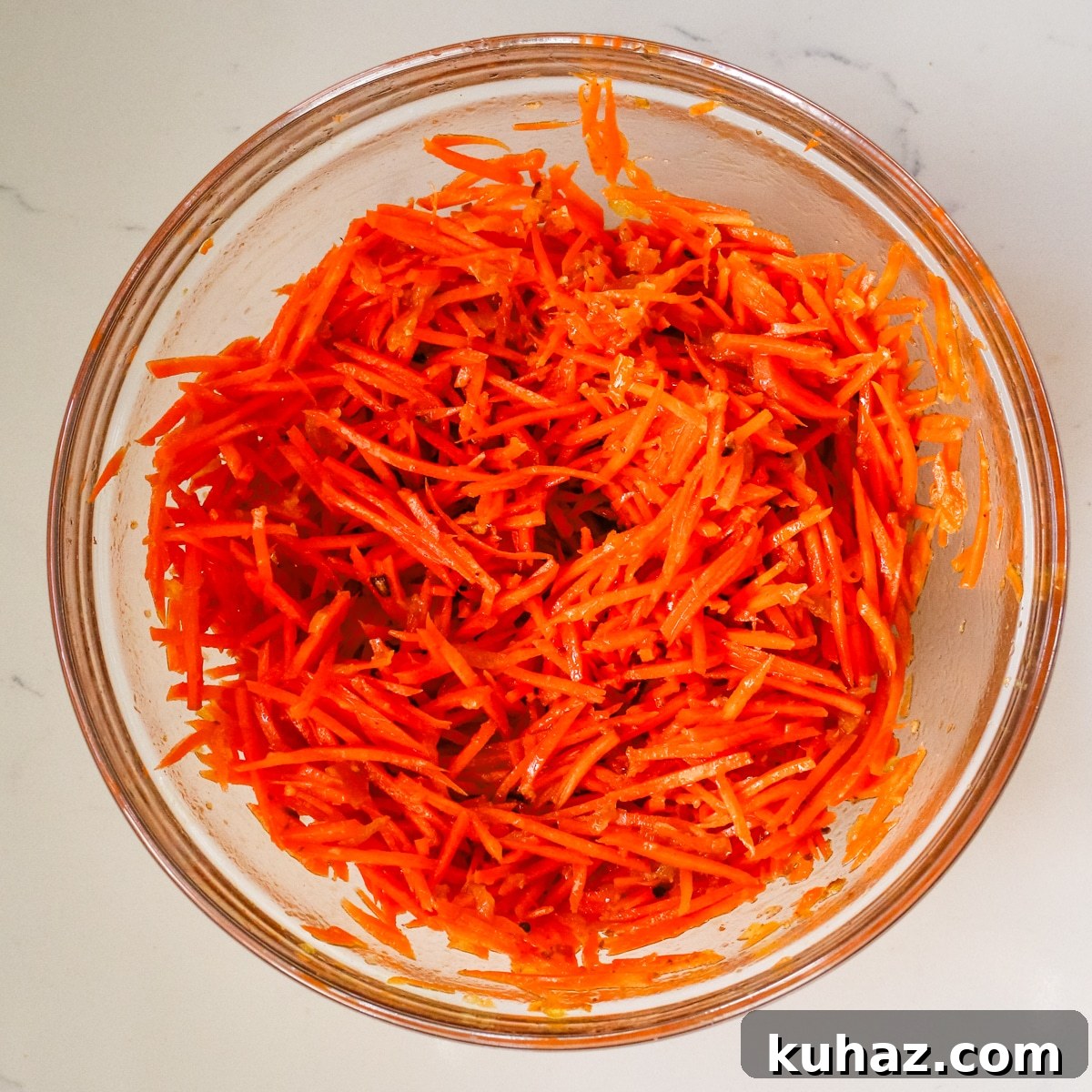 Spicy Morkovcha Korean Carrot Salad Recipe 8 korean carrot salad mixture in glass bowl.