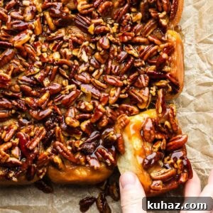 Homemade Gooey Sticky Buns Recipe from Scratch 9 Hands grabbing a sticky bun.