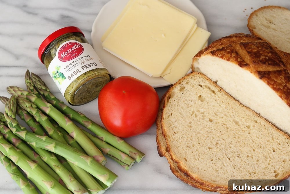 Roasted Asparagus and Tomato Pesto Melt Recipe 3 ingredients for the roasted asparagus tomato pesto melt on marble background