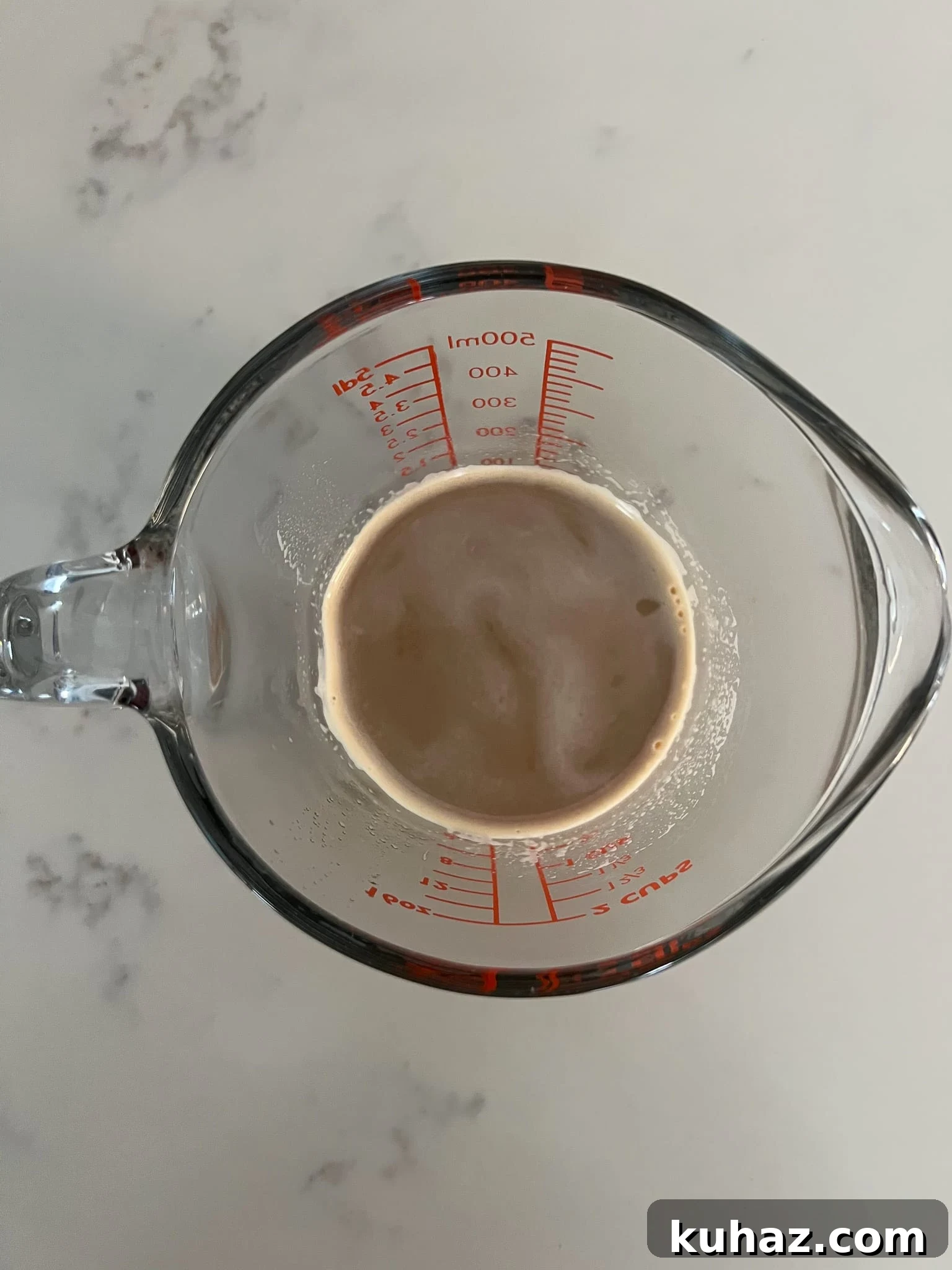 Coffee and milk mixed together.