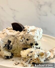 A piece of Cookies and Cream sheet cake with a forked bite.
