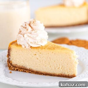 Creamy Eggnog Cheesecake Recipe for the Holidays 7 A slice of eggnog cheesecake on a plate next to a glass of milk.