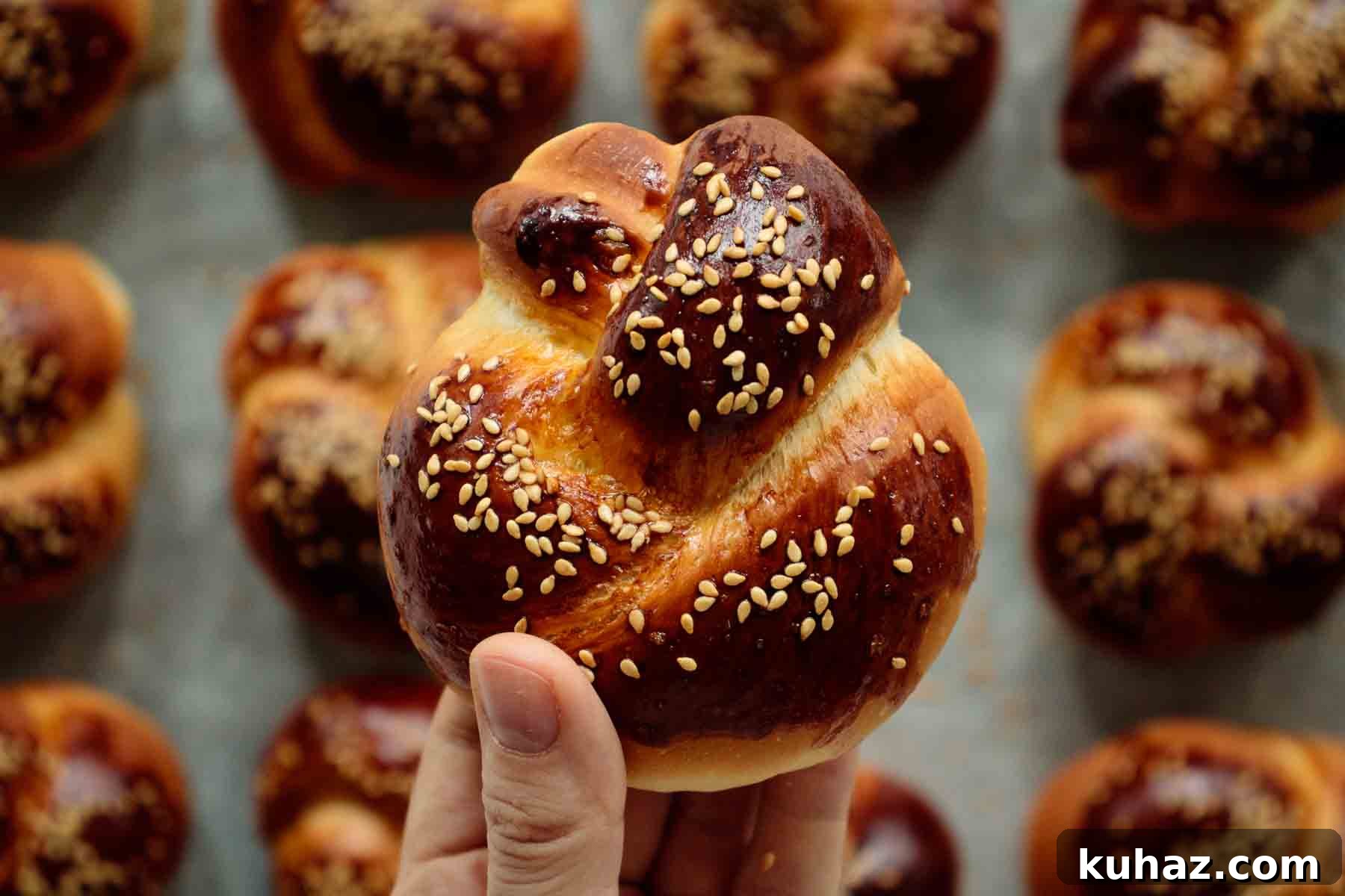 Soft Challah Rolls Recipe for Fluffy Challah Buns 15 Hand holding a challah roll.