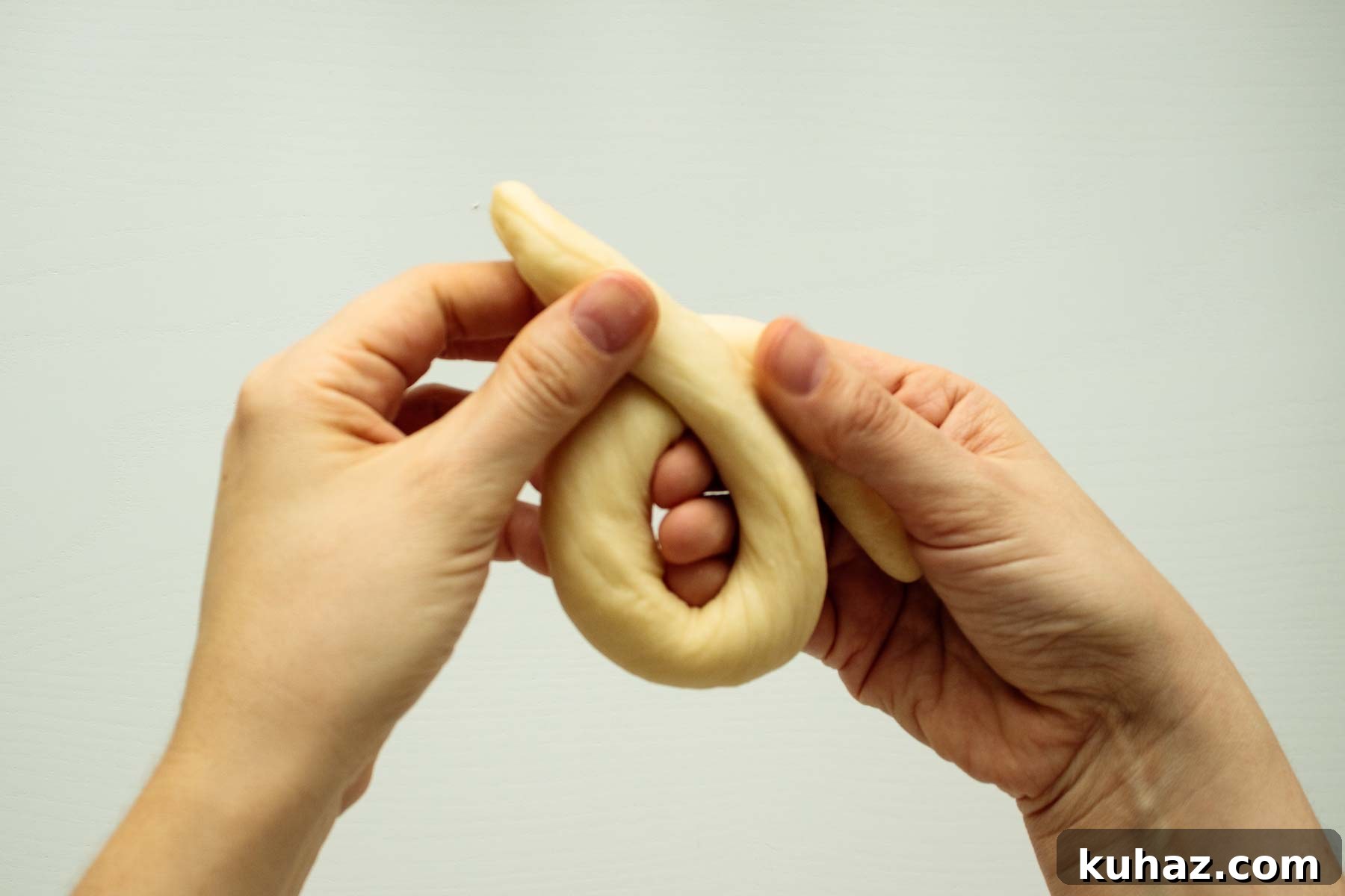 Soft Challah Rolls Recipe for Fluffy Challah Buns 9 Hands twisting dough.