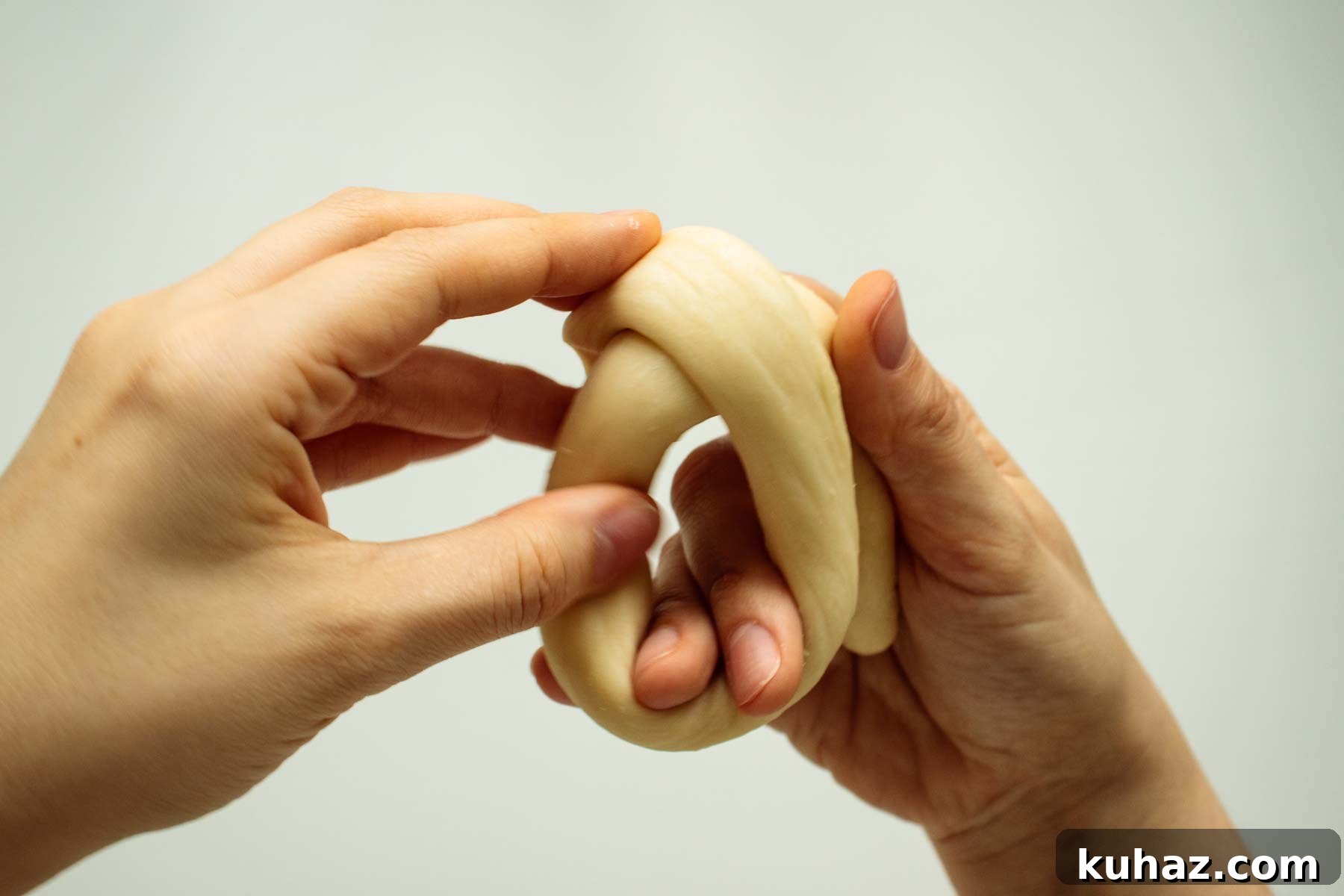 Soft Challah Rolls Recipe for Fluffy Challah Buns 10 Hands shaping dough.
