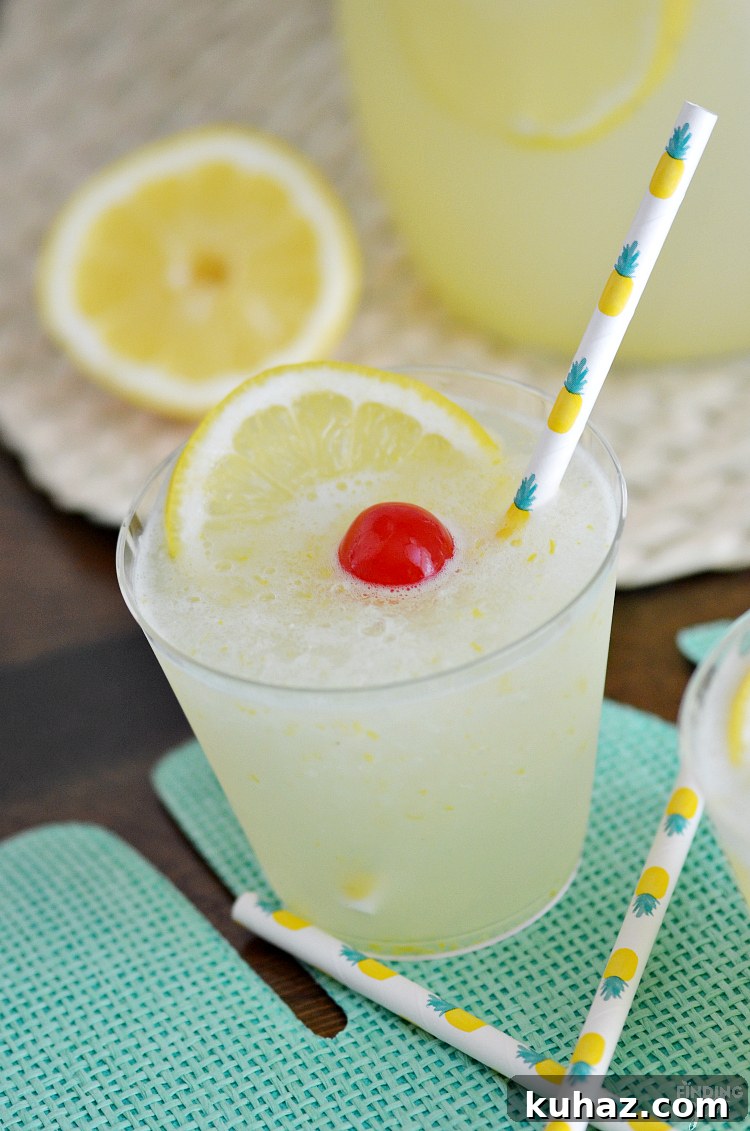 Beat the summer heat with this refreshing Homemade Frozen Lemonade recipe! Made with fresh lemons, this frothy drink is simple and delicious! Make this kid friendly drink at your next celebration.