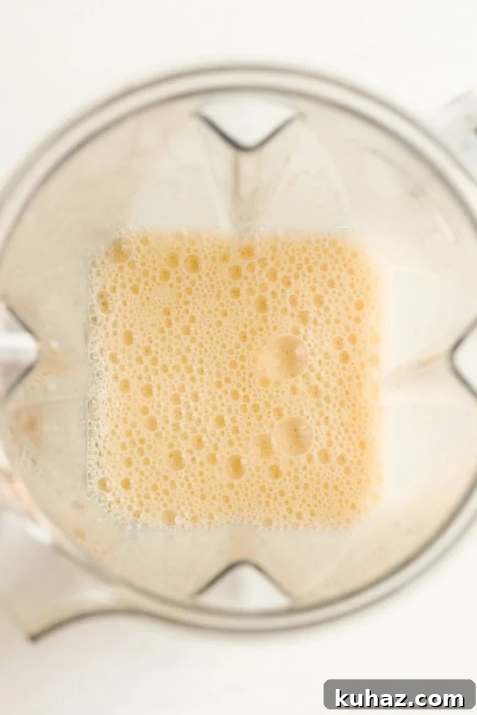 Orange Banana Smoothie Recipe 7 blended orange fruit smoothie in a blender