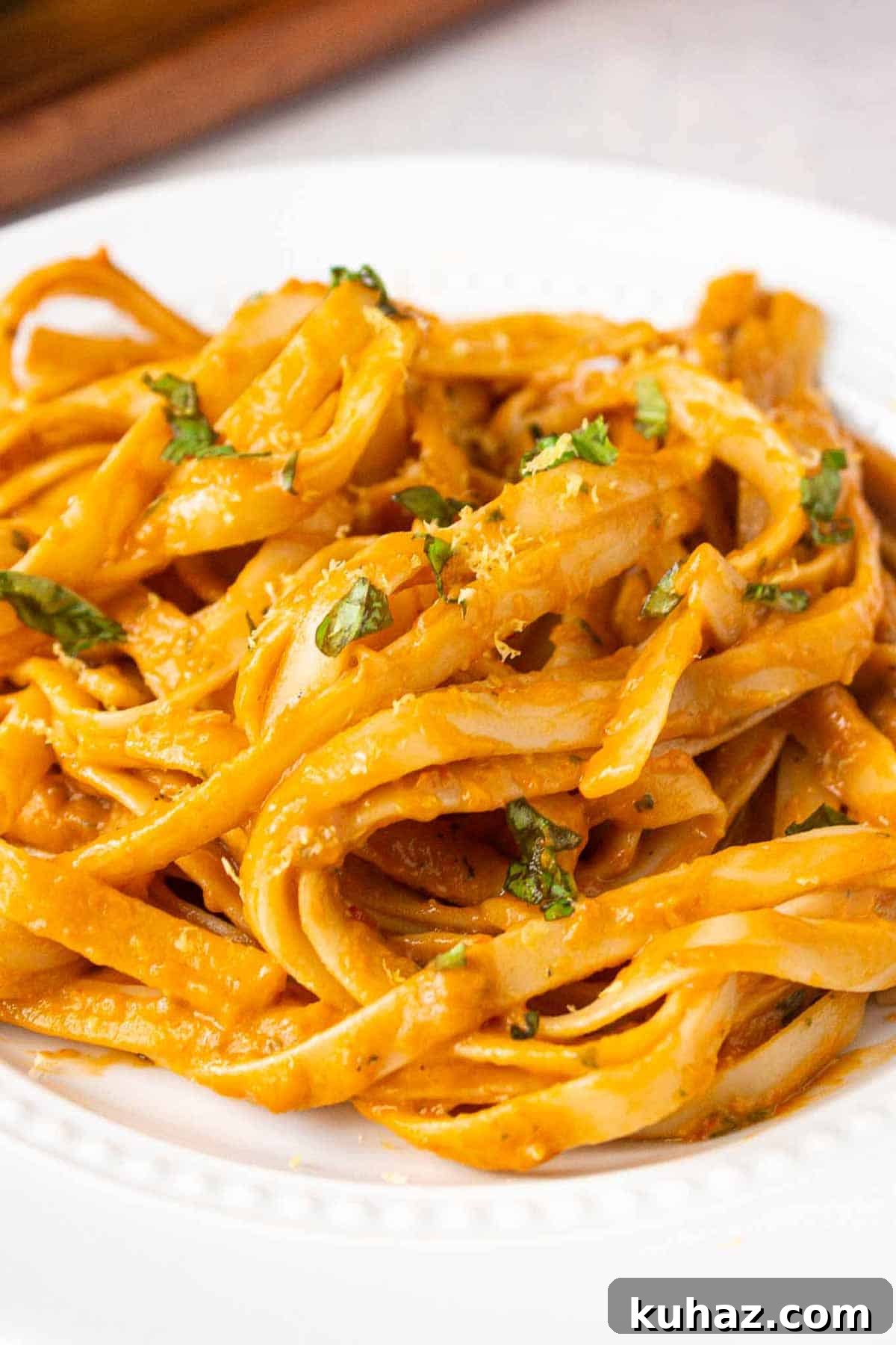 Creamy Avocado Bell Pepper Pasta 10 Fettuccine noodles coated in avocado bell pepper sauce garnished with fresh basil and lemon zest.