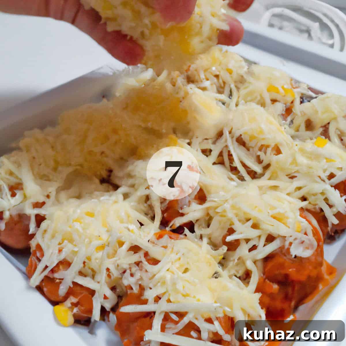 Baked Meatballs in Marinara with Melted Mozzarella 5 Adding shredded cheese to meatballs.