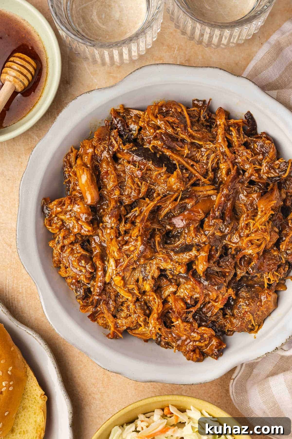 Overhead view of a platter of shredded slow cooker hot honey chicken.