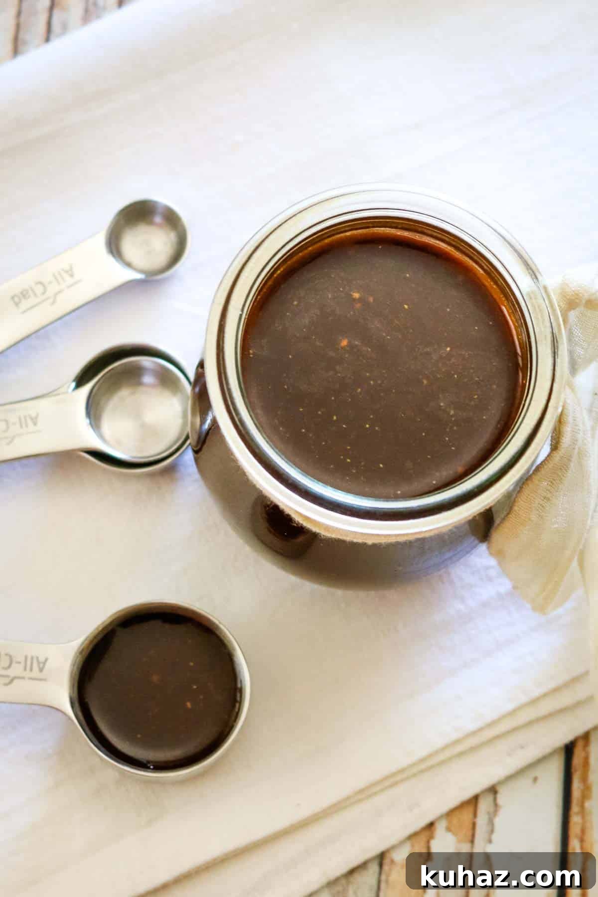 Homemade Worcestershire Sauce Recipe 3 measuring spoons and a small jar of dark Worcestershire sauce