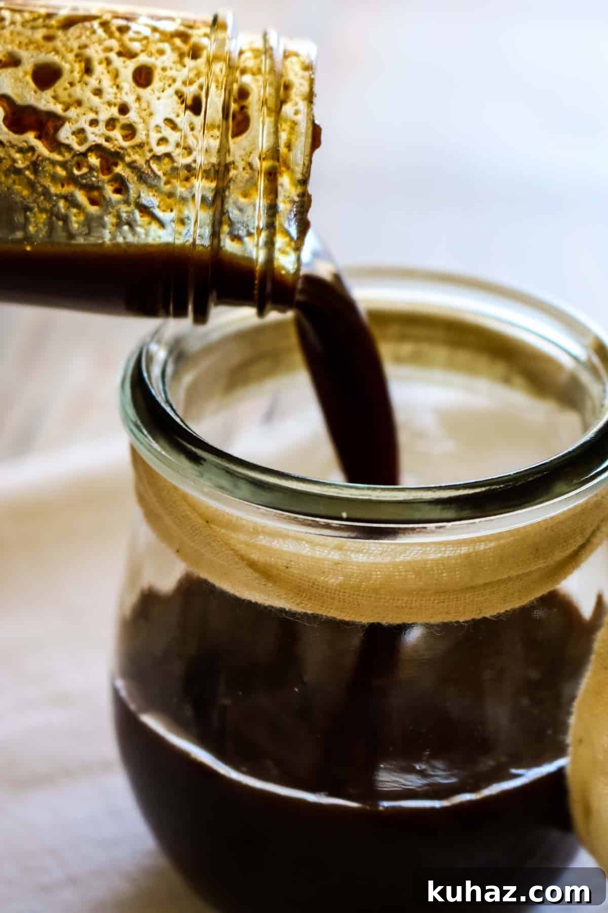 Homemade Worcestershire Sauce Recipe 8 dark Worcestershire sauce being poured into a jar