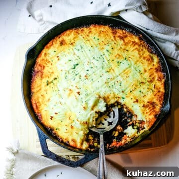shepherd's pie in a cast iron skillet with a spoon