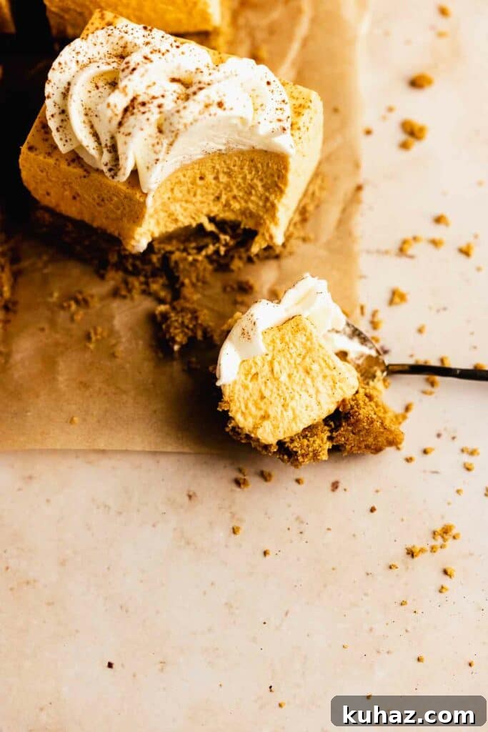 Creamy No-Bake Pumpkin Cheesecake Bars 2 Taking a bite of a cheesecake slice