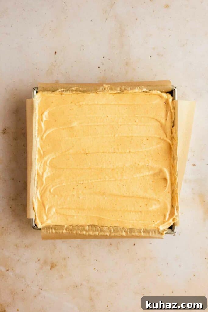 Creamy No-Bake Pumpkin Cheesecake Bars 11 Smoothing cheesecake in the pan