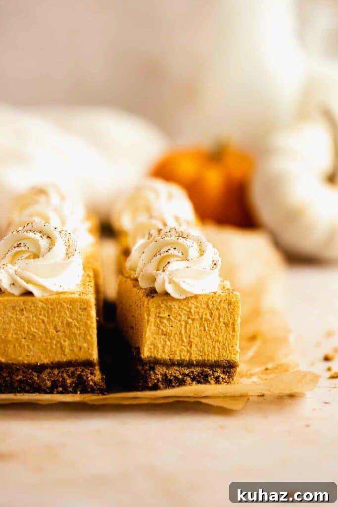 Creamy No-Bake Pumpkin Cheesecake Bars 4 Pumpkin cheesecake bars on parchment paper