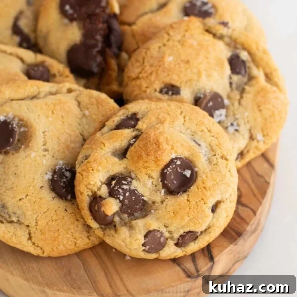 A wooden board filled with sourdough chocolate chip cookies.