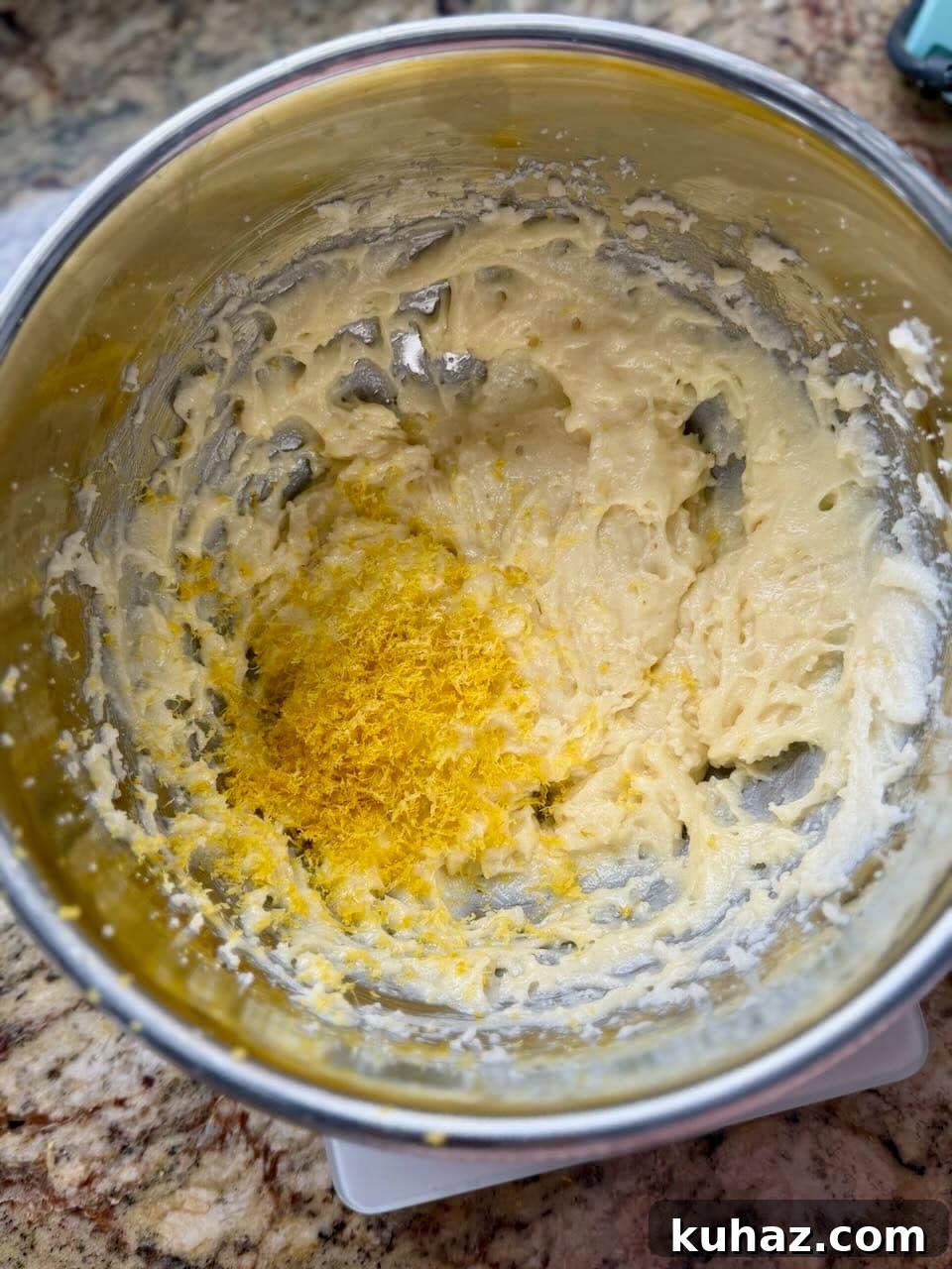 Lemon Crinkle Cookies Made with Sourdough Discard 5 Lemon zest added to the cookie dough mixture in a mixing bowl for lemon crinkle cookies.