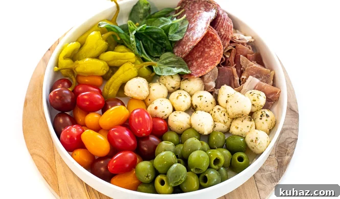 Ingredients for the Christmas antipasto wreath in a big, white bowl.