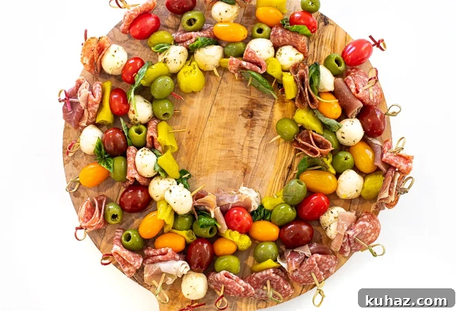 Antipasto on skewers in the shape of a circle on a wooden surface.