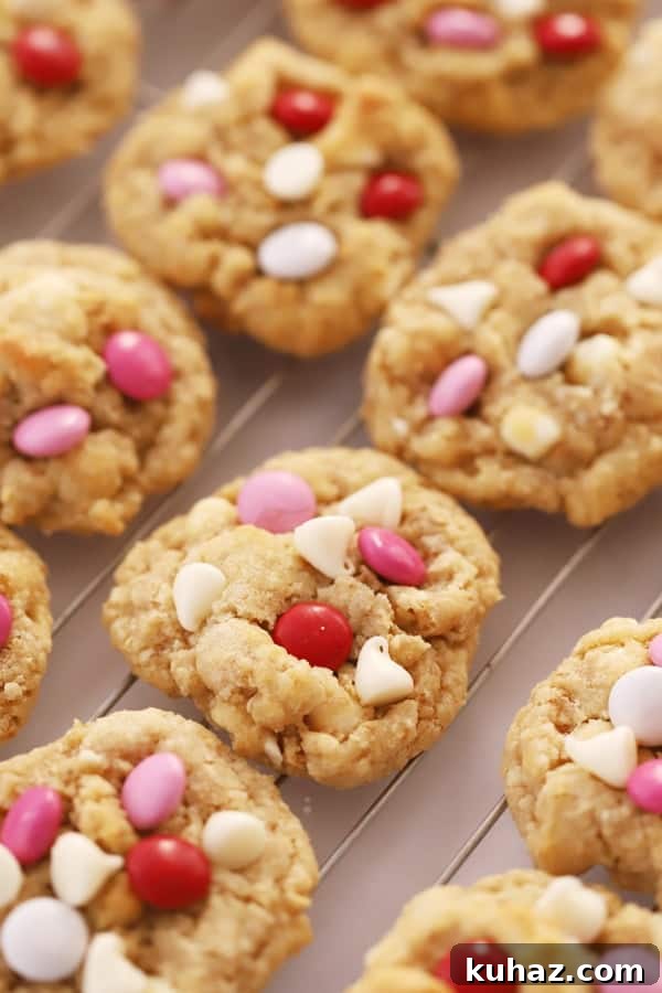 A cooling rack full of white chocolate coconut cookies.