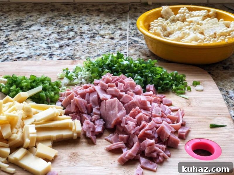 Corn and Gruyere Frittata with Canadian Bacon (4 WW Points) 5 The ingredients for the healthy frittata recipe, gruyere, chives, pepper, and ham sitting on a cutting board