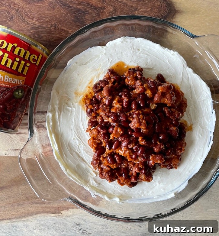 3-Ingredient Chili Cheese Dip Recipe 5 Warm Chili Cream Cheese Dip! A delicious and easy party food. It's warm, cheesy, quick to make, and crowd pleasing!