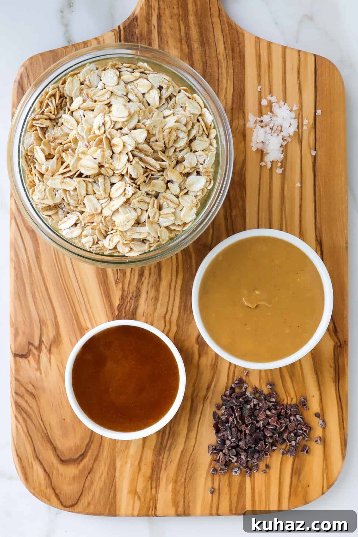 No-Bake Peanut Butter Bliss Balls: Protein-Packed Bites 4 Ingredients on a wooden board.