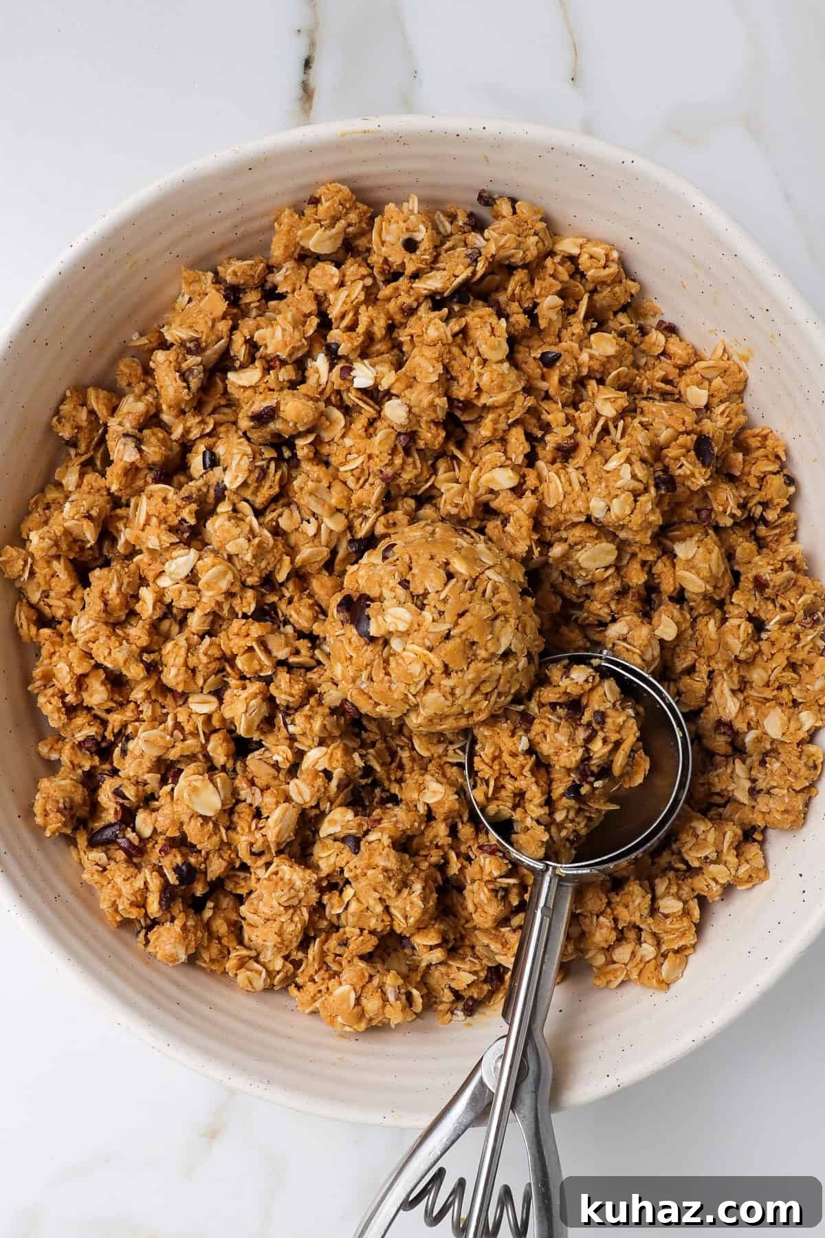 No-Bake Peanut Butter Bliss Balls: Protein-Packed Bites 6 Mixture in a bowl with a cookie scoop.
