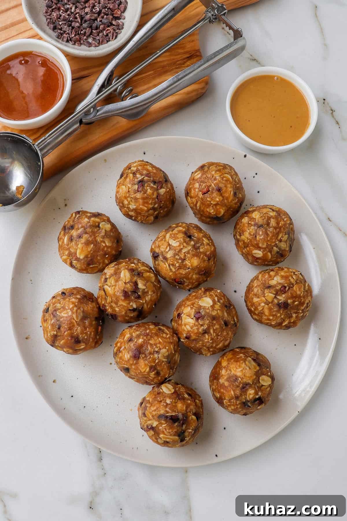 No-Bake Peanut Butter Bliss Balls: Protein-Packed Bites 9 Bliss balls on a plate with peanut butter and ingredients on the side.