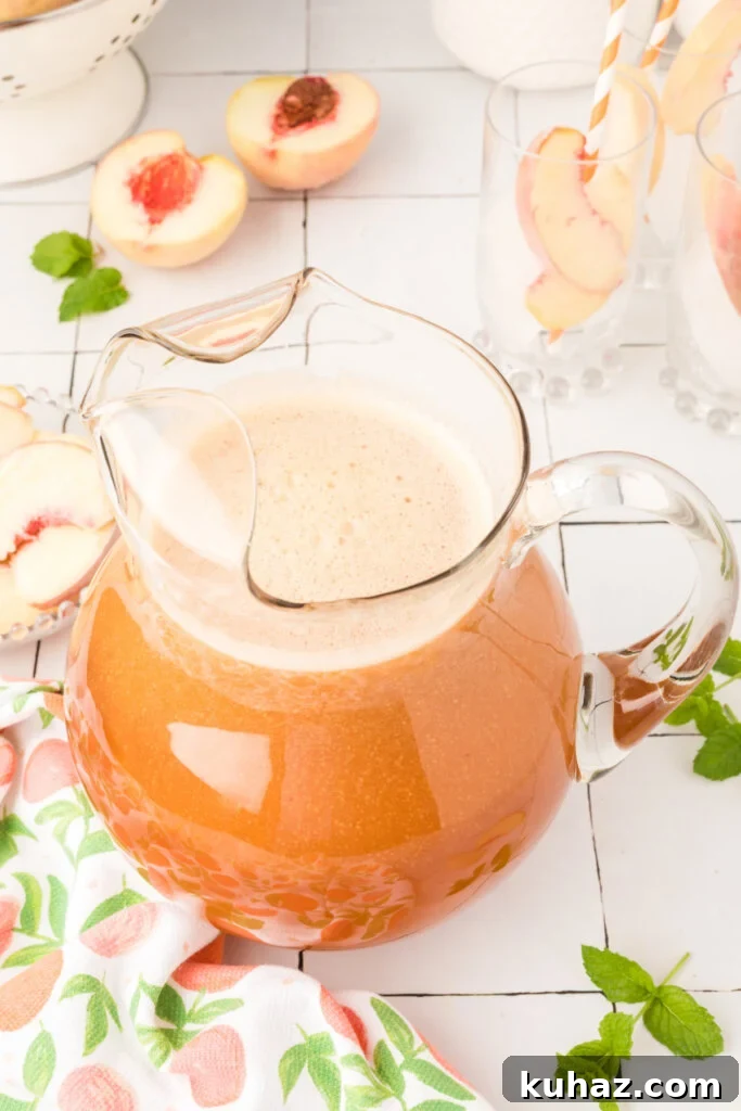 Southern Peach Iced Tea Recipe with Fresh Peaches 3 looking down onto a pitcher of southern peach tea