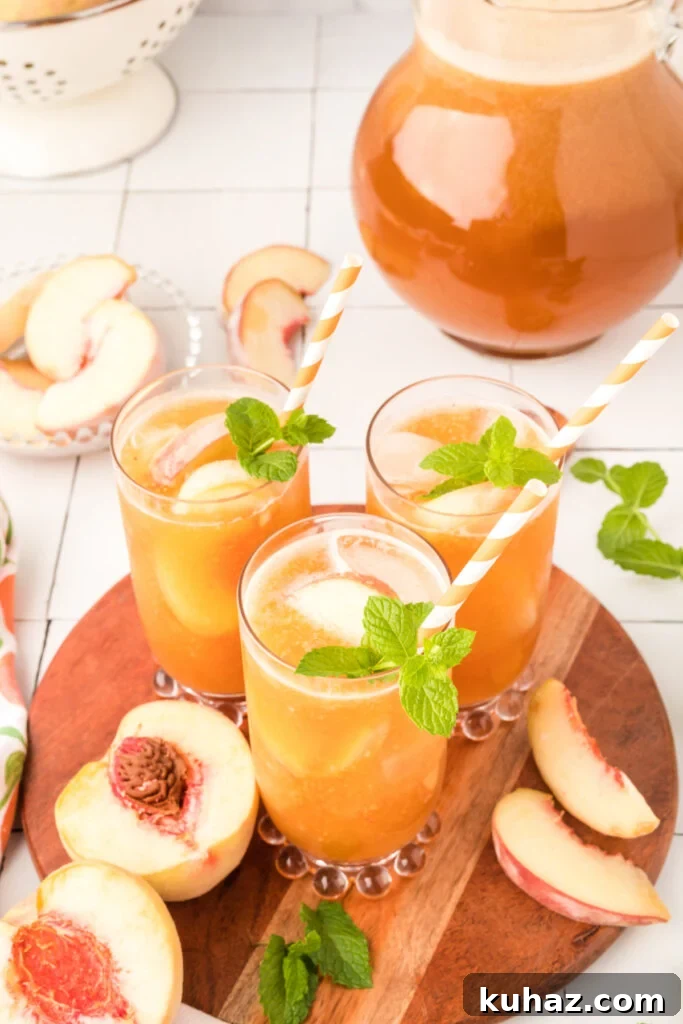 Southern Peach Iced Tea Recipe with Fresh Peaches 4 glasses of peach iced tea on wooden serving tray