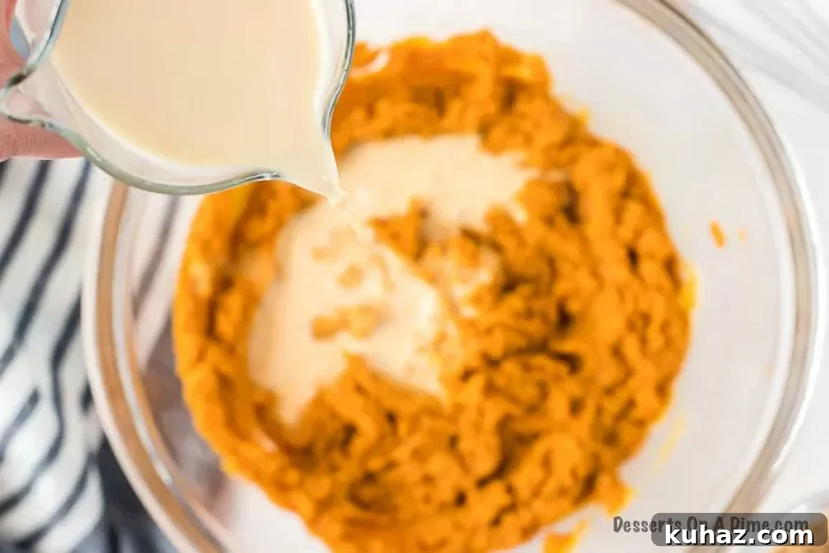 Classic Creamy Pumpkin Pie with Flaky Crust 6 Pour evaporated milk with the pumpkin pie mixture