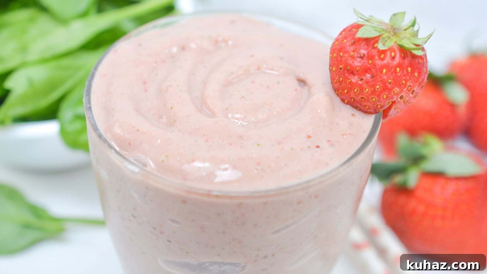 13 Gluten-Free Breakfast Recipes to Kickstart Your Morning 4 Side view of spinach strawberry smoothie in glass.