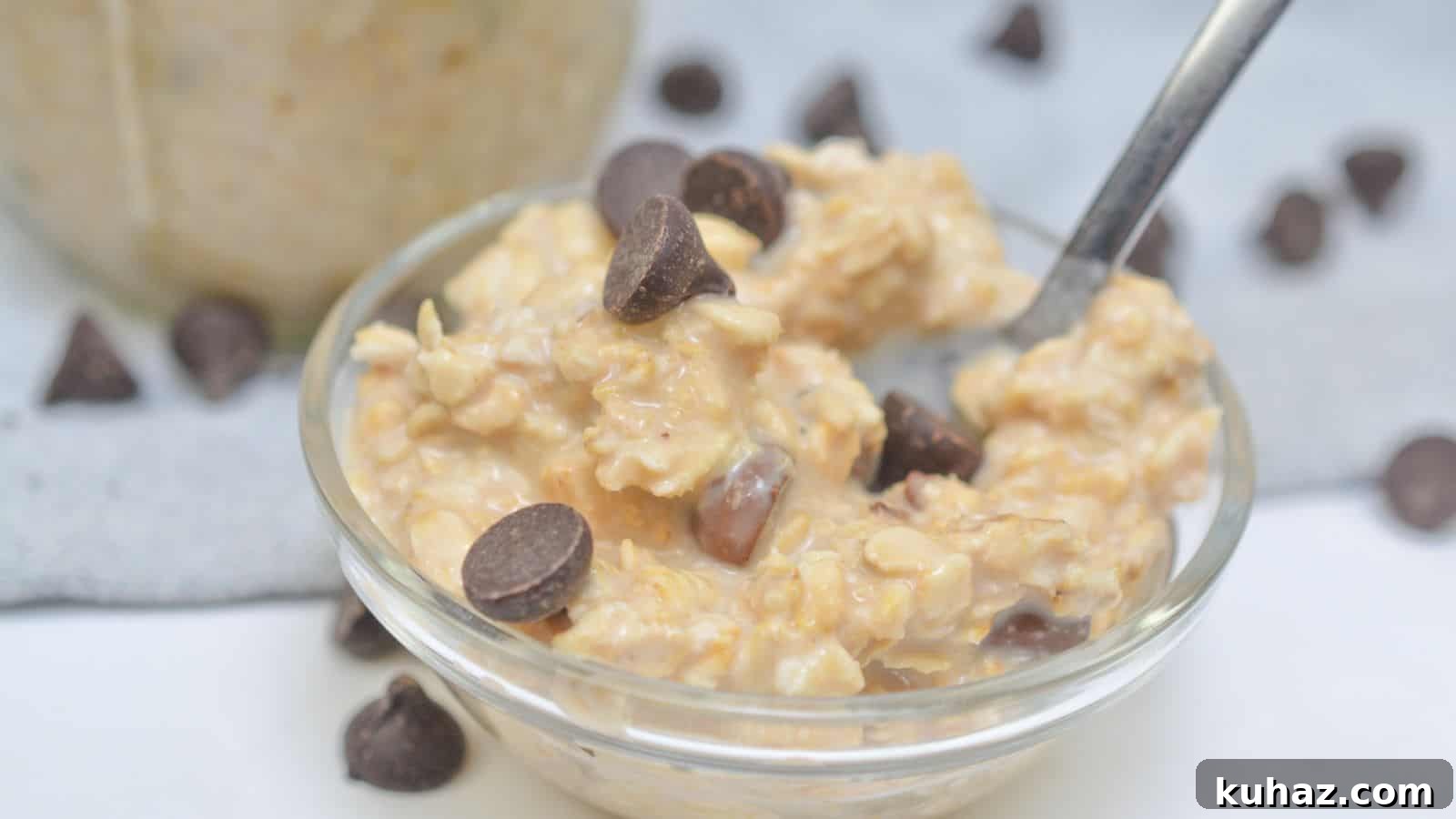 13 Gluten-Free Breakfast Recipes to Kickstart Your Morning 6 A bowl of oatmeal with chocolate chips on a white surface, a jar of oatmeal and scattered chocolate chips in the background.