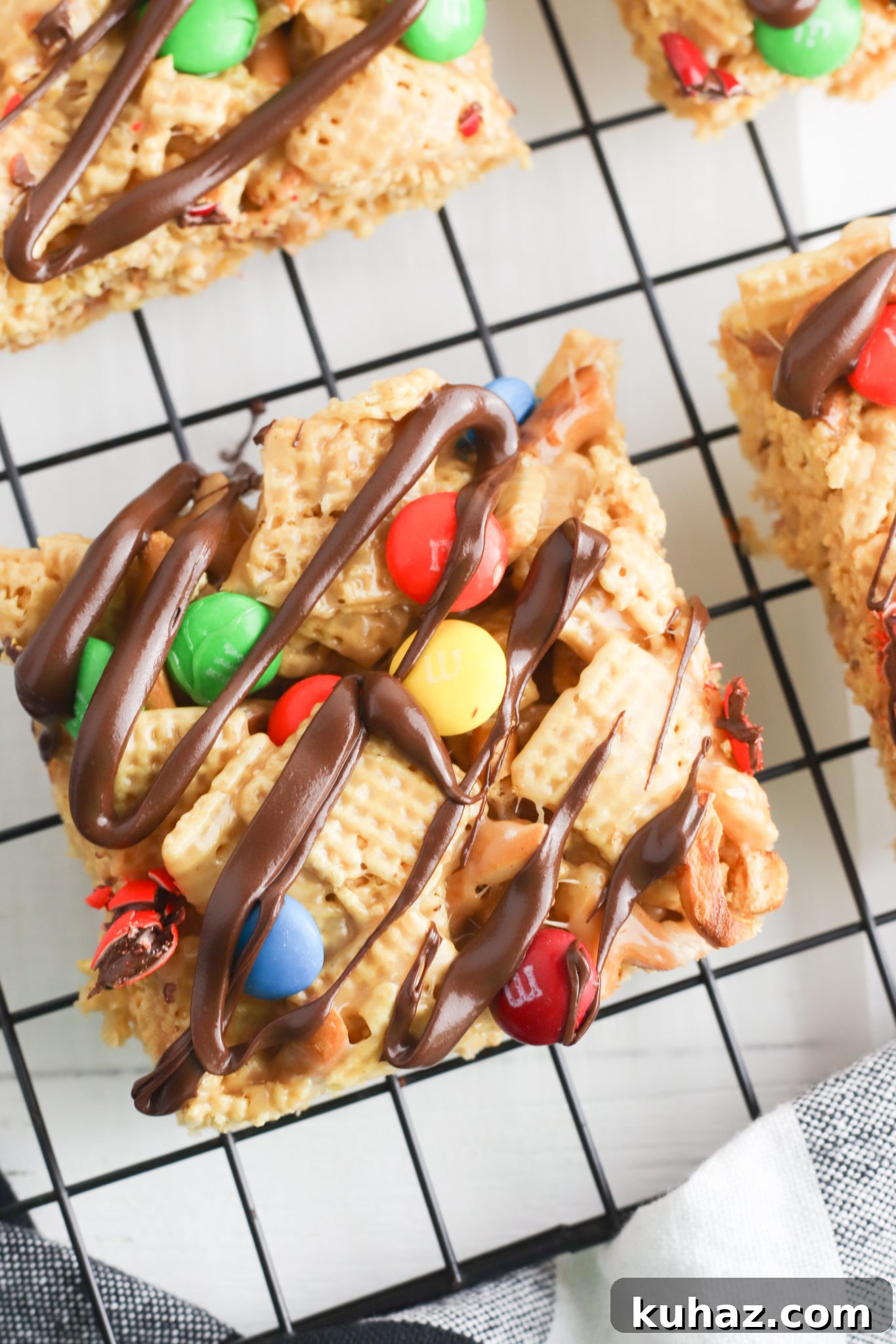 No-Bake Peanut Butter Chex Bars Recipe 3 Close up of a peanut butter chex bar with chocolate drizzle.