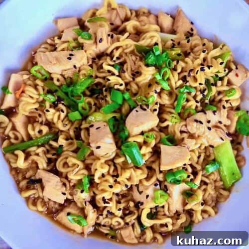 Savory chicken ramen stir-fry with black sesame seeds and scallions.