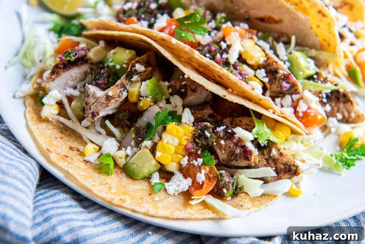 Grilled Chimichurri Chicken Tacos with Lime & Cilantro 5 Grilled chimichurri chicken tacos on a platter.