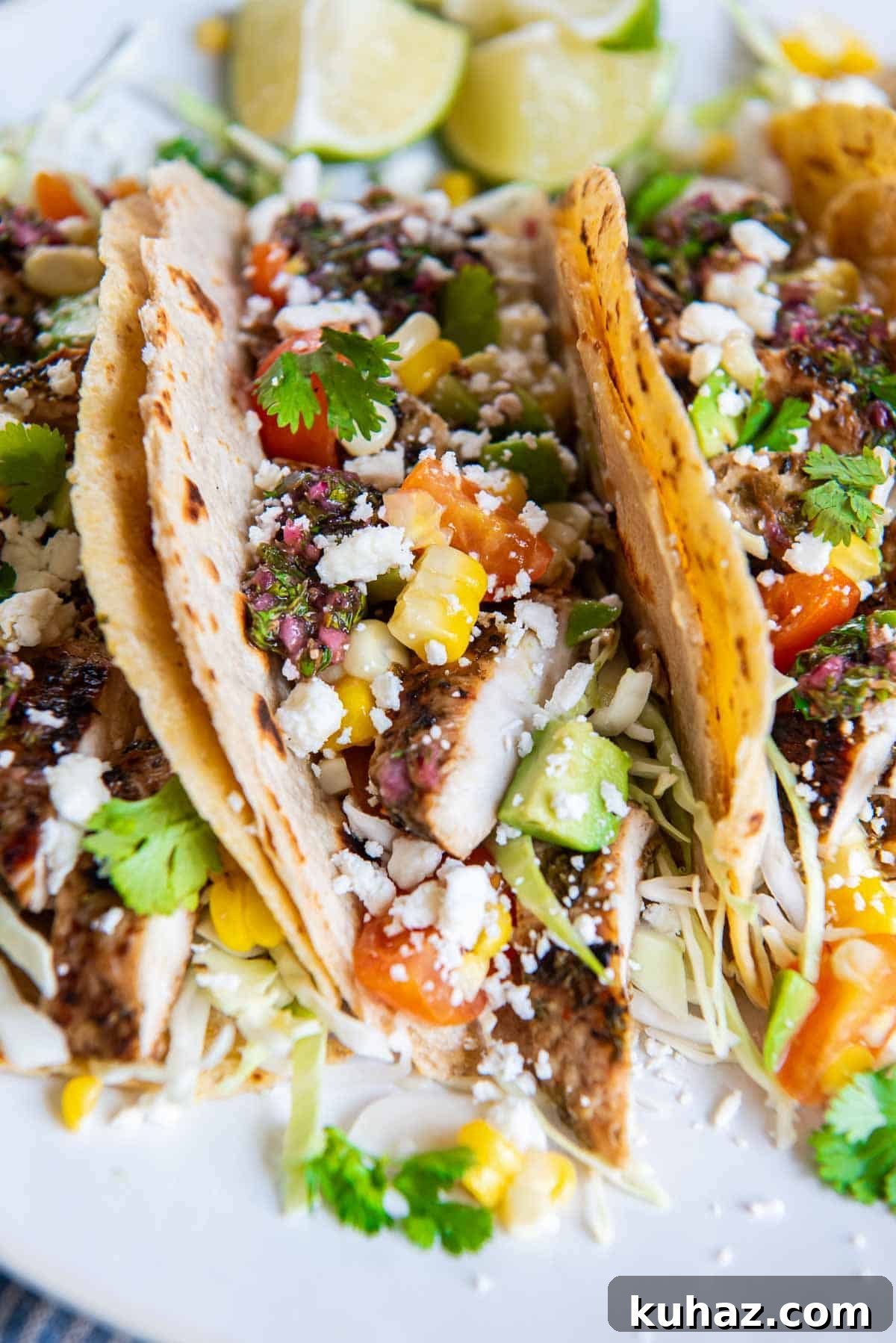 Grilled Chimichurri Chicken Tacos with Lime & Cilantro 8 Chimichurri tacos on corn tortillas with cabbage, corn, tomatoes, and avocado.