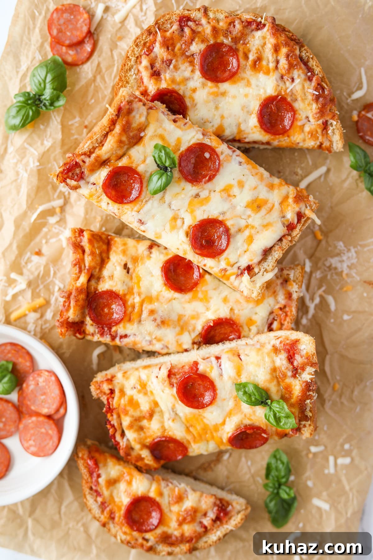 Homemade French Bread Pizza Recipe 11 Rectangular slices of pizza piled up on parchment paper.