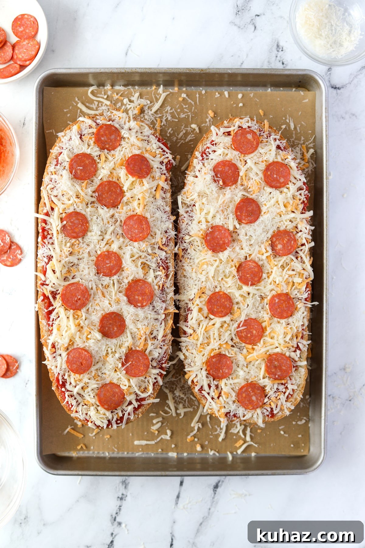 Homemade French Bread Pizza Recipe 7 Two halves of French Bread pizza topped with pepperoni.