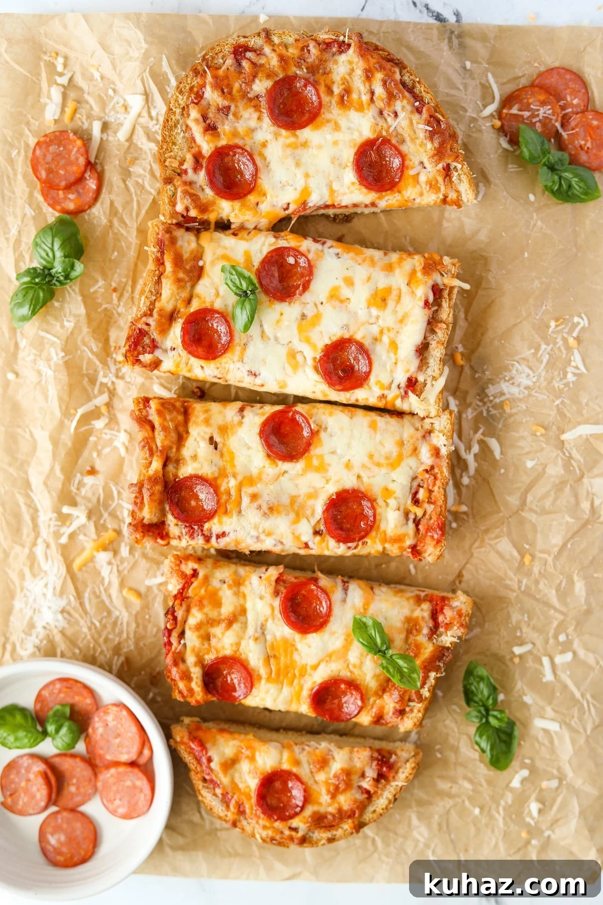 Homemade French Bread Pizza Recipe 9 Pizza bread cut into slices on a baking sheet.