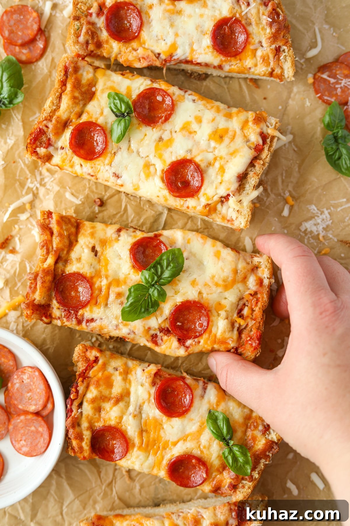 Homemade French Bread Pizza Recipe 10 A hand taking a slice of French Bread pizza.
