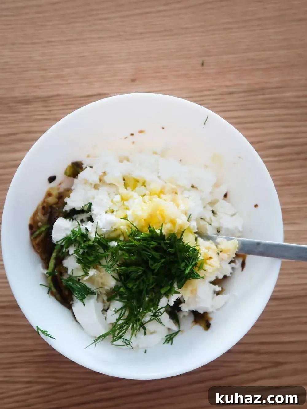 Mixing feta and zucchini for dip